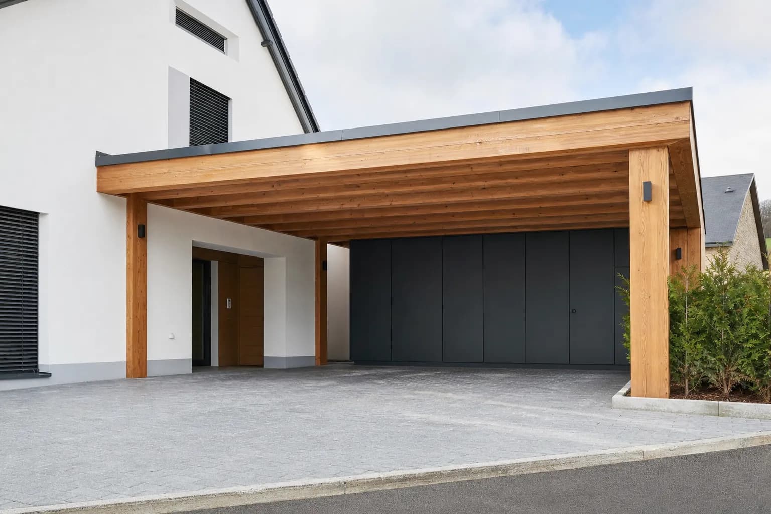 Maßgefertigter Holz-Carport und angrenzende Holzterrasse an einem Einfamilienhaus, gebaut von Blang Holzbau